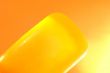 Piece of yellow soap on an orange background