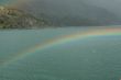 Rainbow, rocky hills and glacier