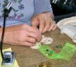 Woman`s Hands Crafting an Ornament