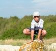 boy sitting on a rock