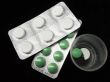 isolated green and white pills on black background