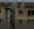 Closeup Ice Pattern on Window with Transparent Opposite House Fragment