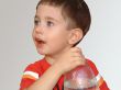 The boy with a bottle on a white background
