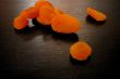 Dried apricots on black surface
