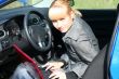 young woman with notebook in car.