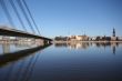 Old Town Panorama with River and Bridge Fragment in Sunny Day