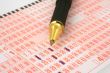 lottery ticket and pen