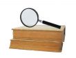 two old books and magnifying glass