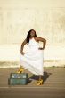 African American woman with suitcases laughs