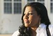 African American Woman close up in front of Hangar