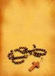 wooden rosary against retro background