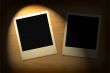 two old photo frames lit in darkness