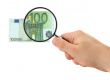 hand magnifying 100 Euro note
