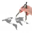 hand with compasses on world map