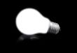 close-up of lit light bulb on black