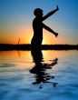 sunset silhouette doing excercises