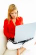 Women with laptop on couch