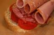 Sandwich with sausage and tomatoes close up