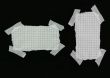 squared strip of paper with white plaster pieces