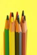 bunch of colorful pencils on yellow background
