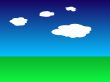 Green earth and blue sky with clouds