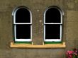  Two arched windows in textured stonework