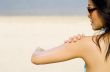 Applying Suncream At Beach