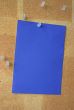 blue paper sheet pinned to corkboard