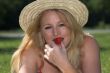 Pretty woman eating a strawberry