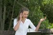 Businesswoman in the park; annoyed