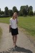 Pretty businesswoman in the park; on the phone
