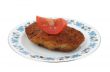 steak with tomato on a patterned plate