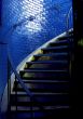 Spiral staircase and stark blue walls