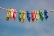 Clothespins on a cord on a background of the sky