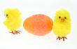two toy chickens with decorated egg