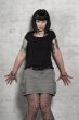 woman leans against a wall
