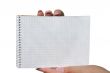 hands holding blank spiral notebook