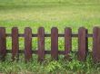 Wooden fence on green grass