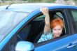 Young woman in a car with key