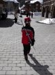 girl walking through ski village