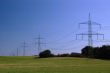 blue sky on grass and transmission facilities