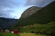 Rural landscape with mountain, field and houses