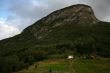 Rural landscape with mountain, field and houses