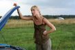 young blond woman with her broken car.