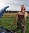 young blond woman with her broken car.