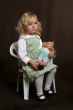 cute little girl in green dress with doll