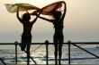 silhouettes of two girls dancing with scarfs