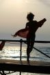 silhouette of women dancing with scarf