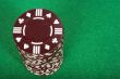 brown pile of casino chips over green