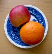 Apple and orange in blue plate